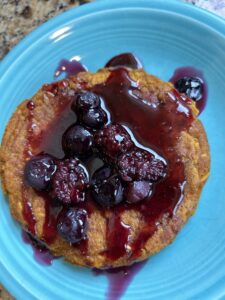 Pumpkin oat pancakes served with mixed berry syrup for a fall breakfast.