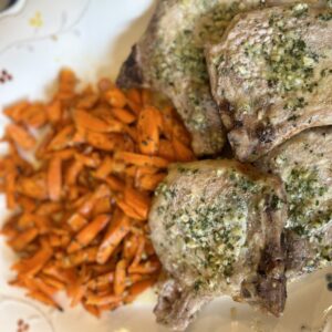 Sheet pan roasted pork chops with assorted vegetables, an easy and flavorful weeknight dinner.”